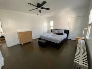 a en suite bathroom with a granite countertop sink and a large mirror