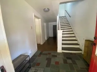 a view of entryway and hall with wooden floor