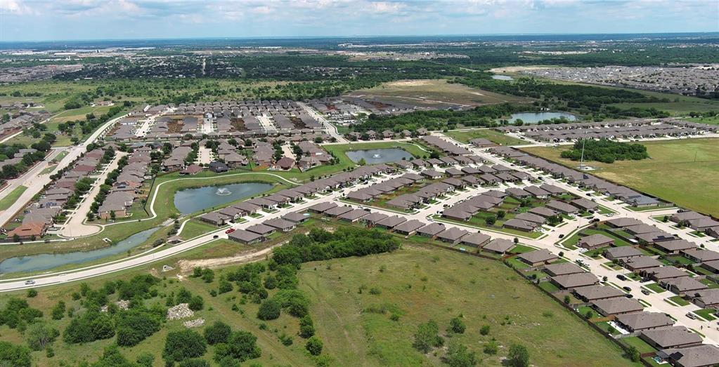 4600 Fringetree Way Crowley, TX 76036 - Photo 33 of 40 Aerial perspective showcasing a residential community with multiple streets and individual homes, punctuated by two ponds featuring water fountains