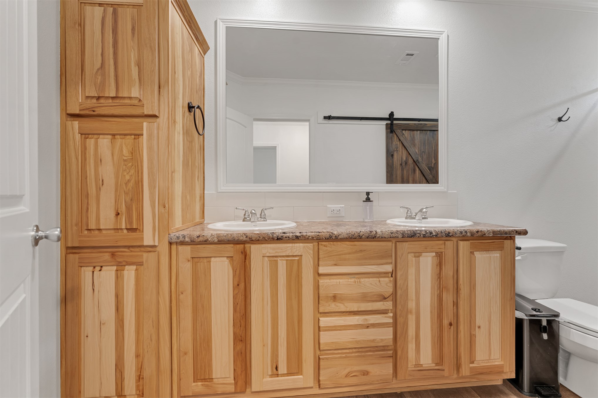 15291 East 400 Road Claremore, OK 74017 - Photo 43 of 96 Dual vanity with integrated sinks, wood-finish cabinetry, and a large framed mirror