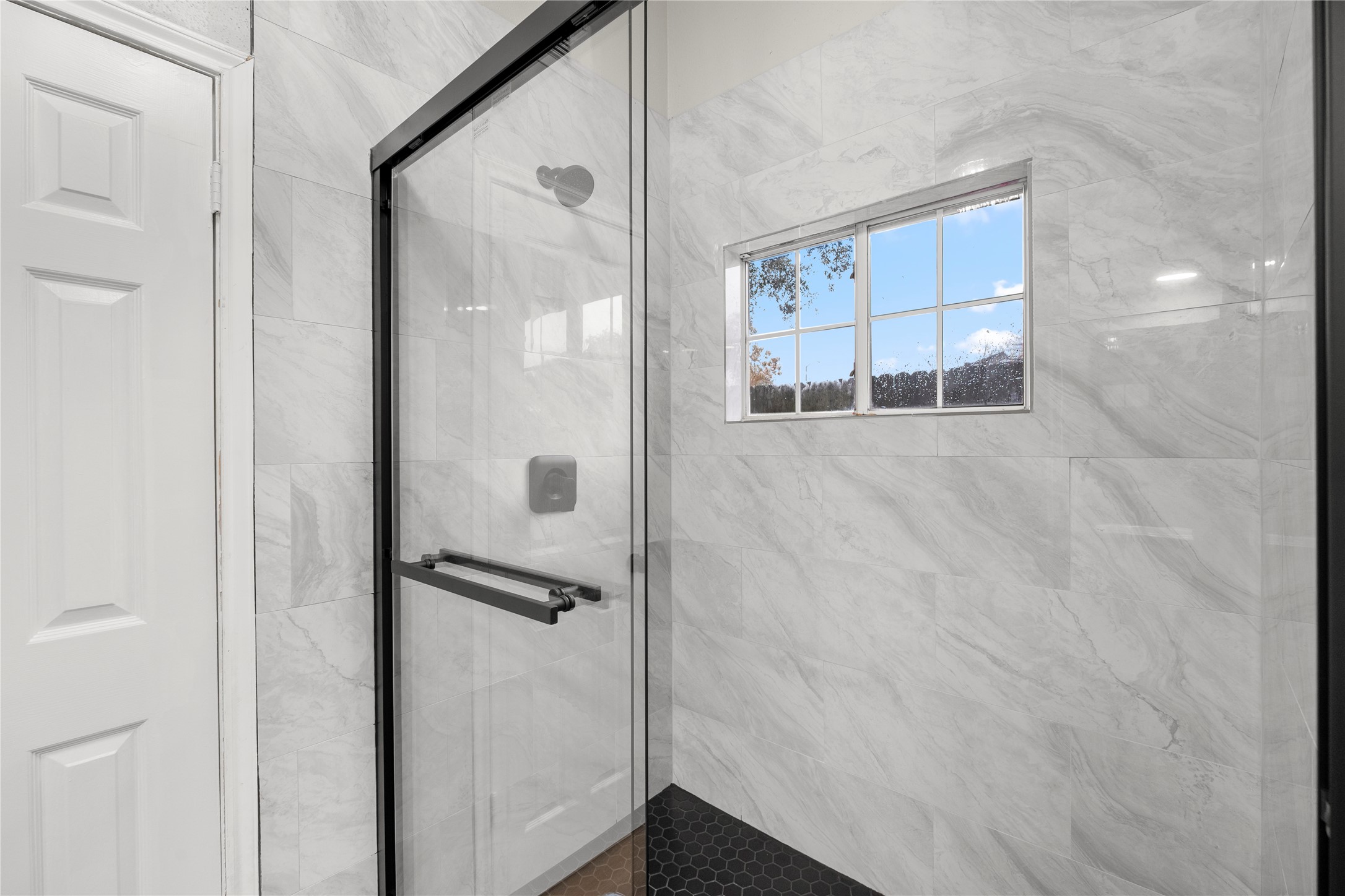 20066 Moonflower Lane Katy, TX 77449 - Photo 17 of 20 a bathroom with a glass shower door