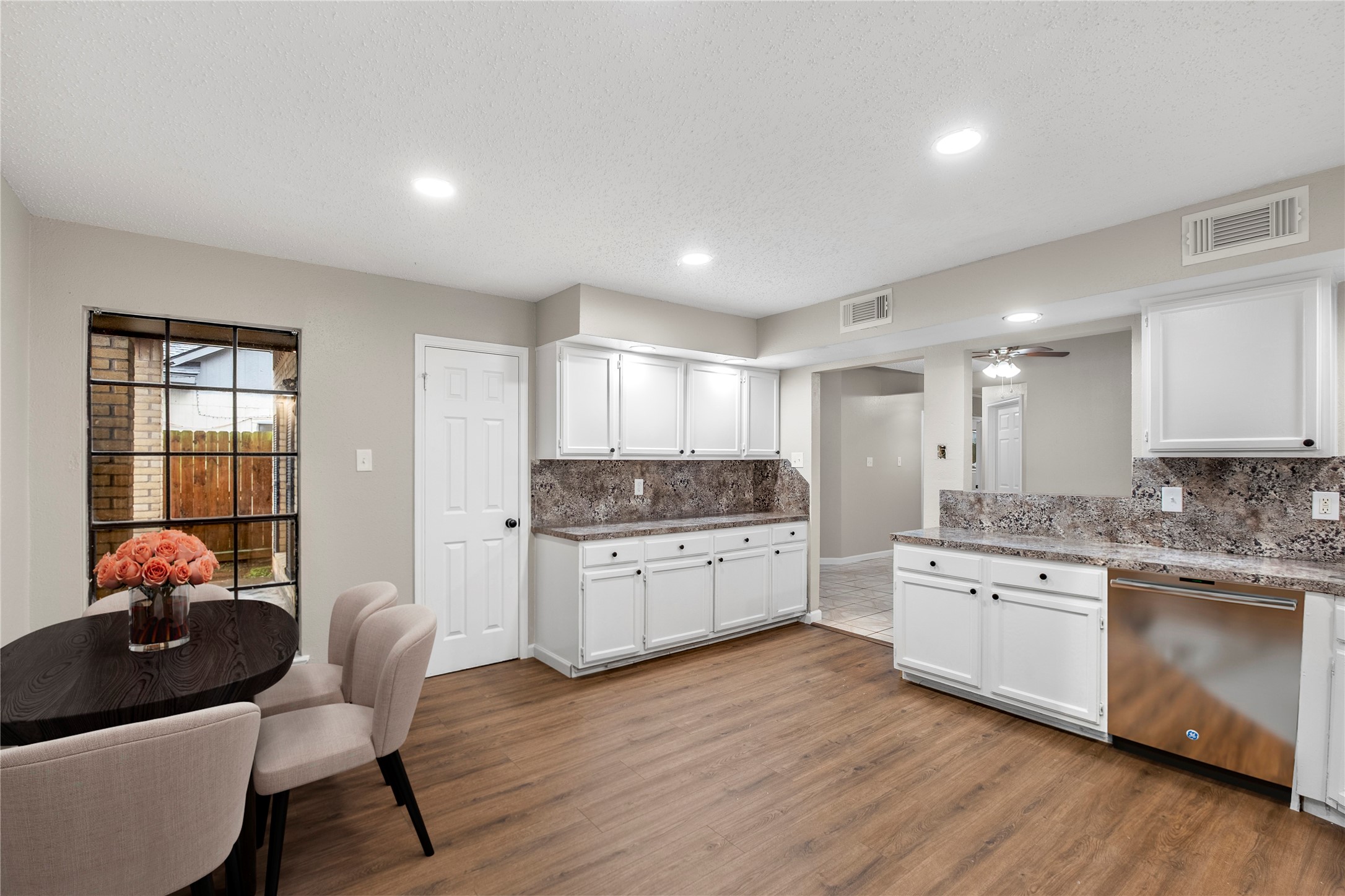 20066 Moonflower Lane Katy, TX 77449 - Photo 6 of 20 a kitchen with stainless steel appliances granite countertop a stove and white cabinets