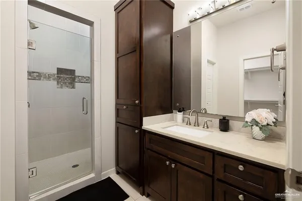 a bathroom with double vanity and a mirror