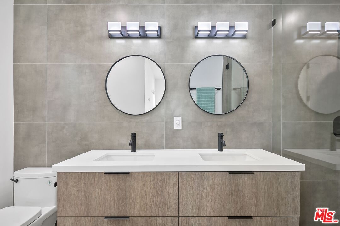 1236 North Spaulding Avenue, Unit 3 West Hollywood, CA 90046 - Photo 13 of 20 a bathroom with a sink and a mirror