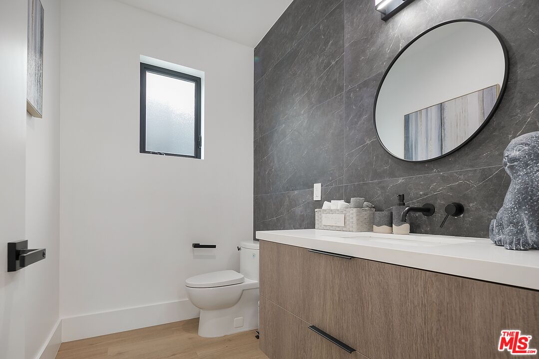 1236 North Spaulding Avenue, Unit 3 West Hollywood, CA 90046 - Photo 15 of 20 a bathroom with a toilet a sink and mirror