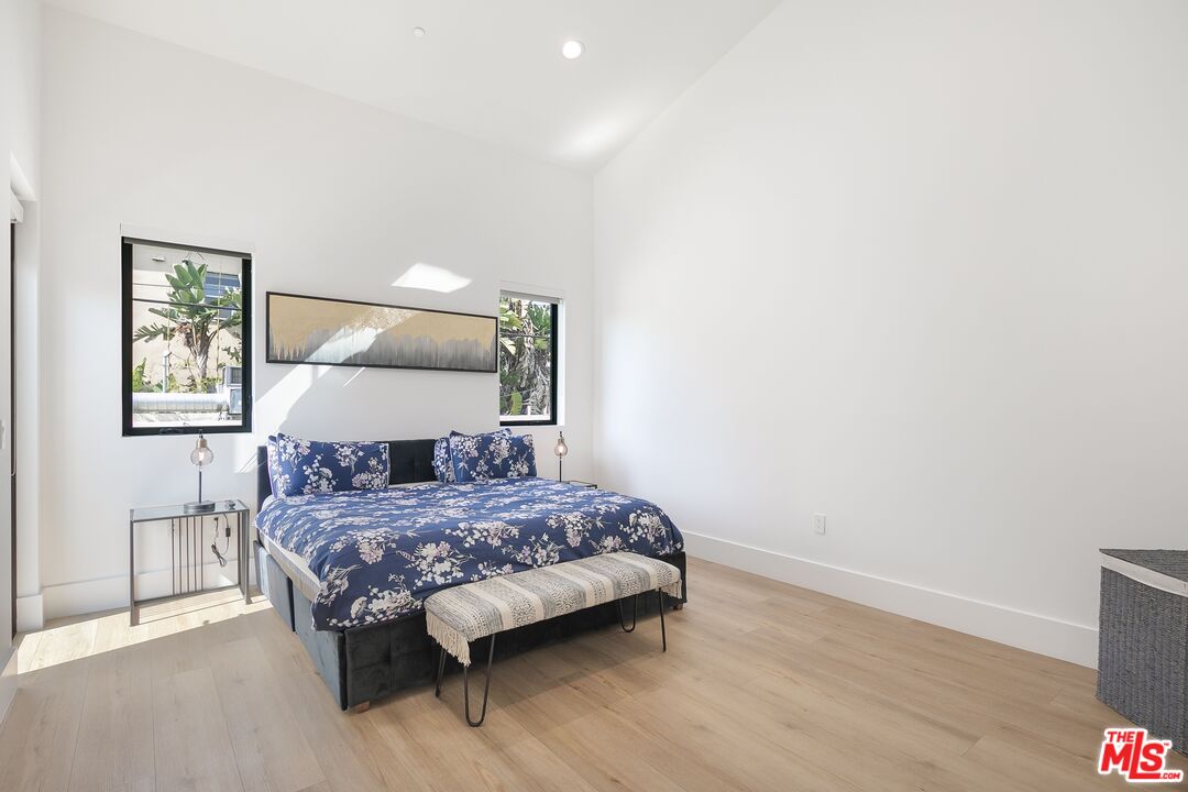1236 North Spaulding Avenue, Unit 3 West Hollywood, CA 90046 - Photo 16 of 20 a bedroom with a bed and wooden floor