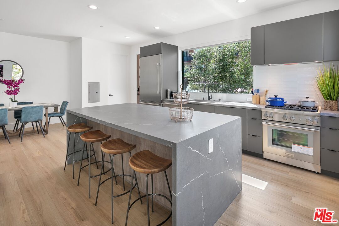 1236 North Spaulding Avenue, Unit 3 West Hollywood, CA 90046 - Photo 6 of 20 a kitchen with a table chairs sink and cabinets