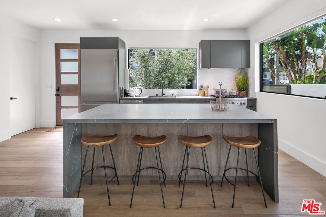 1236 North Spaulding Avenue, Unit 3 West Hollywood, CA 90046 - Photo 8 of 20 a kitchen with a table chairs sink and wooden floor