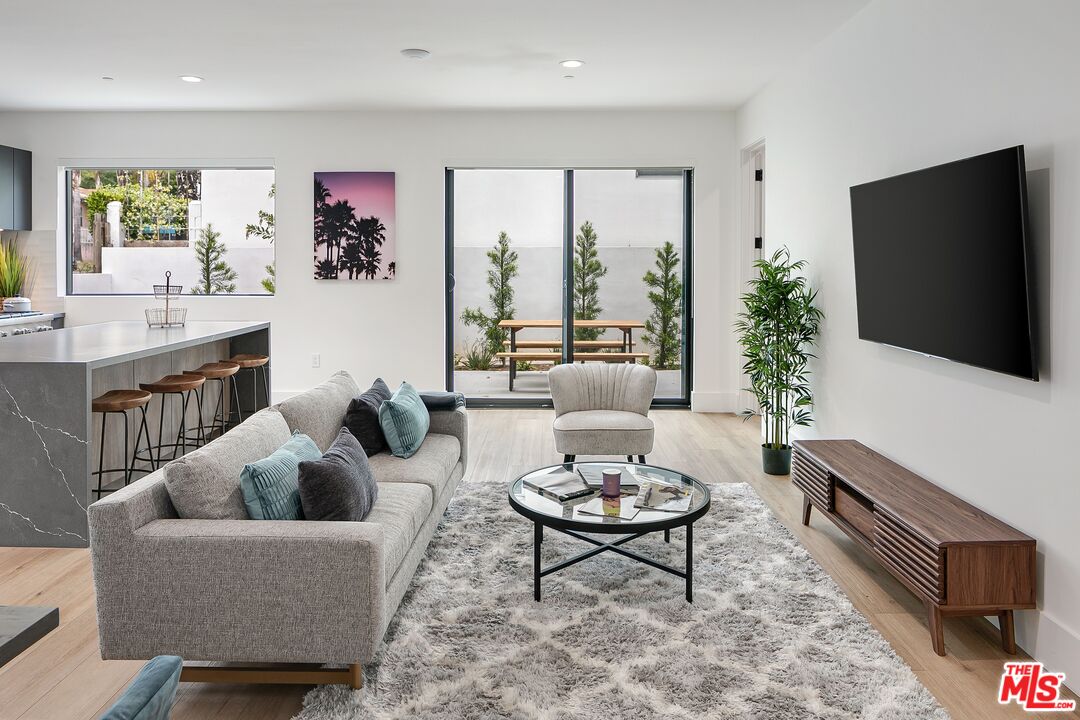 1236 North Spaulding Avenue, Unit 3 West Hollywood, CA 90046 - Photo 10 of 20 a living room with furniture potted plant and a flat screen tv