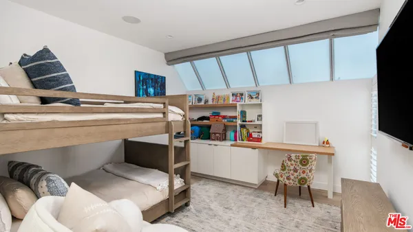 a room with furniture a flat screen tv and a window