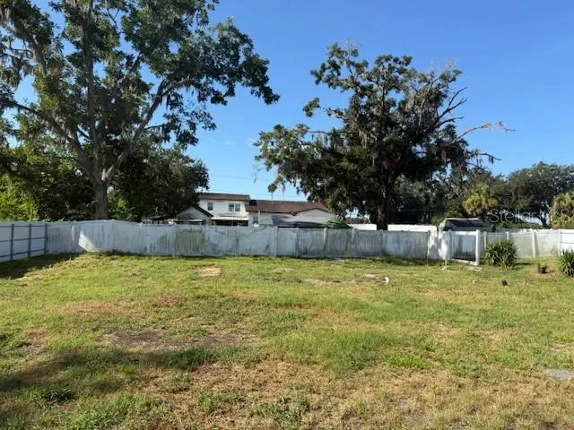 a backyard of apartments with large trees