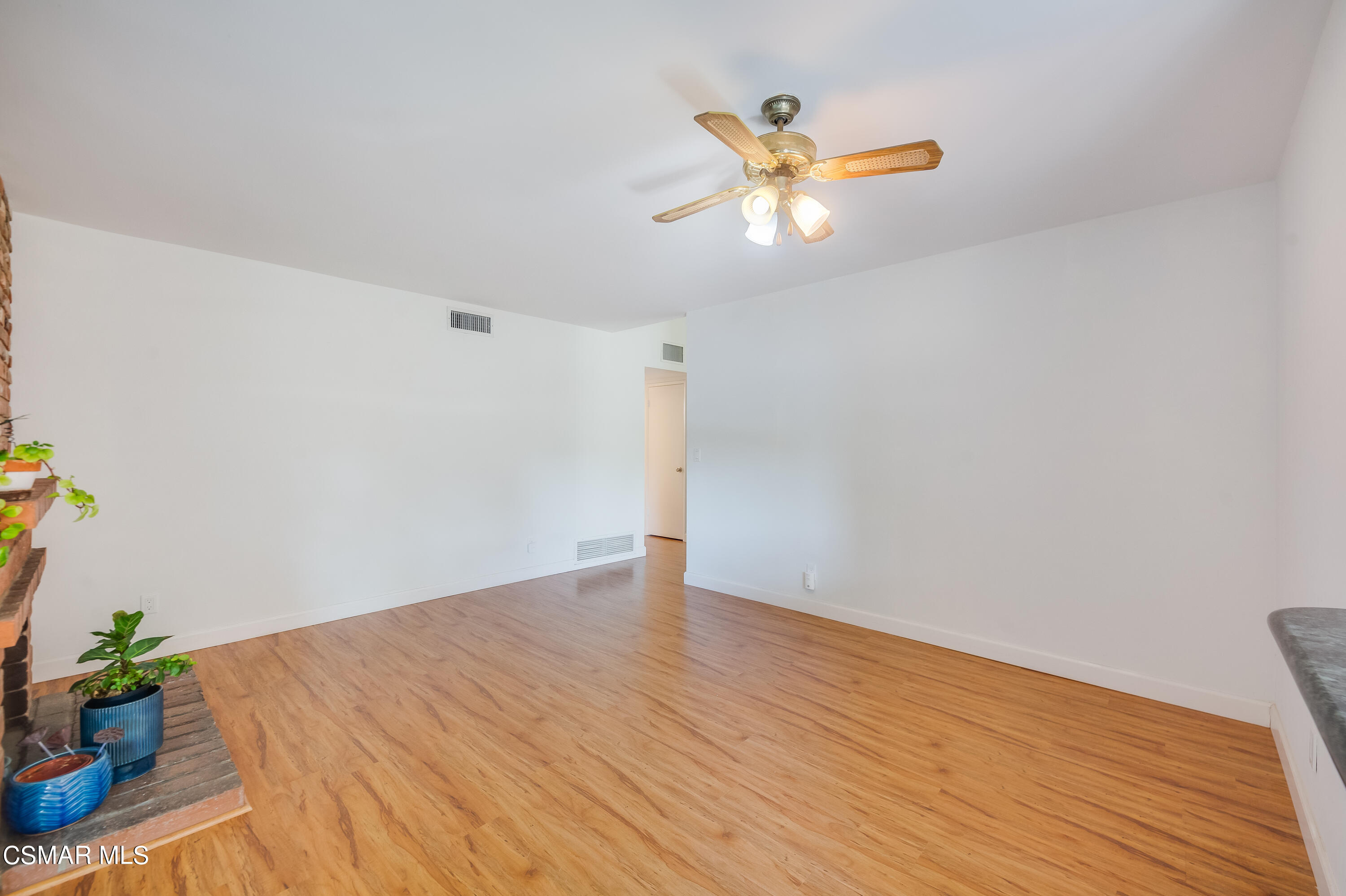 886 Erringer Road Simi Valley, CA 93065 - Photo 6 of 38 a view of an empty room with wooden floor and a chandelier fan