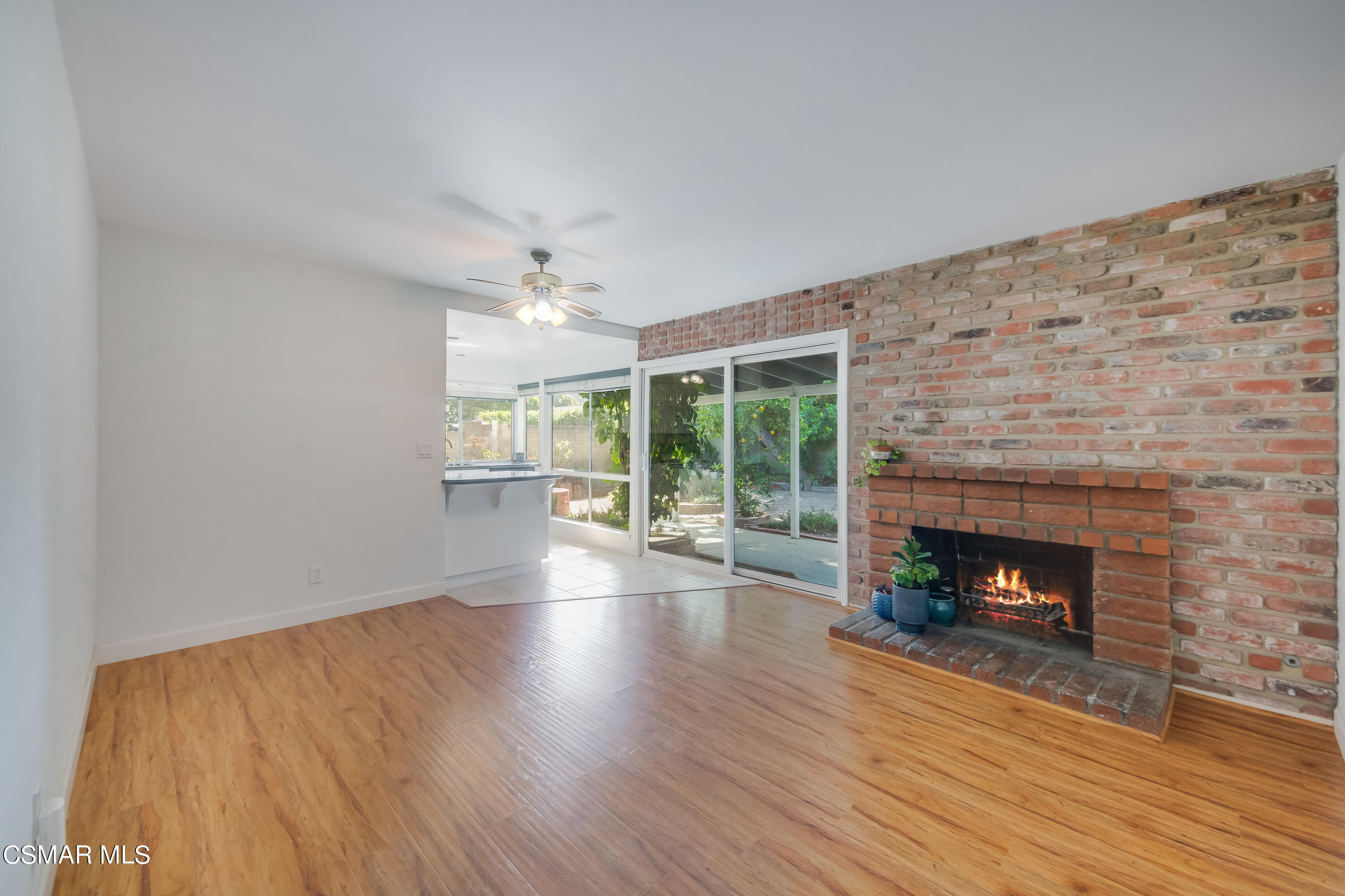 886 Erringer Road Simi Valley, CA 93065 - Photo 7 of 38 a view of an empty room with wooden floor fireplace and a window