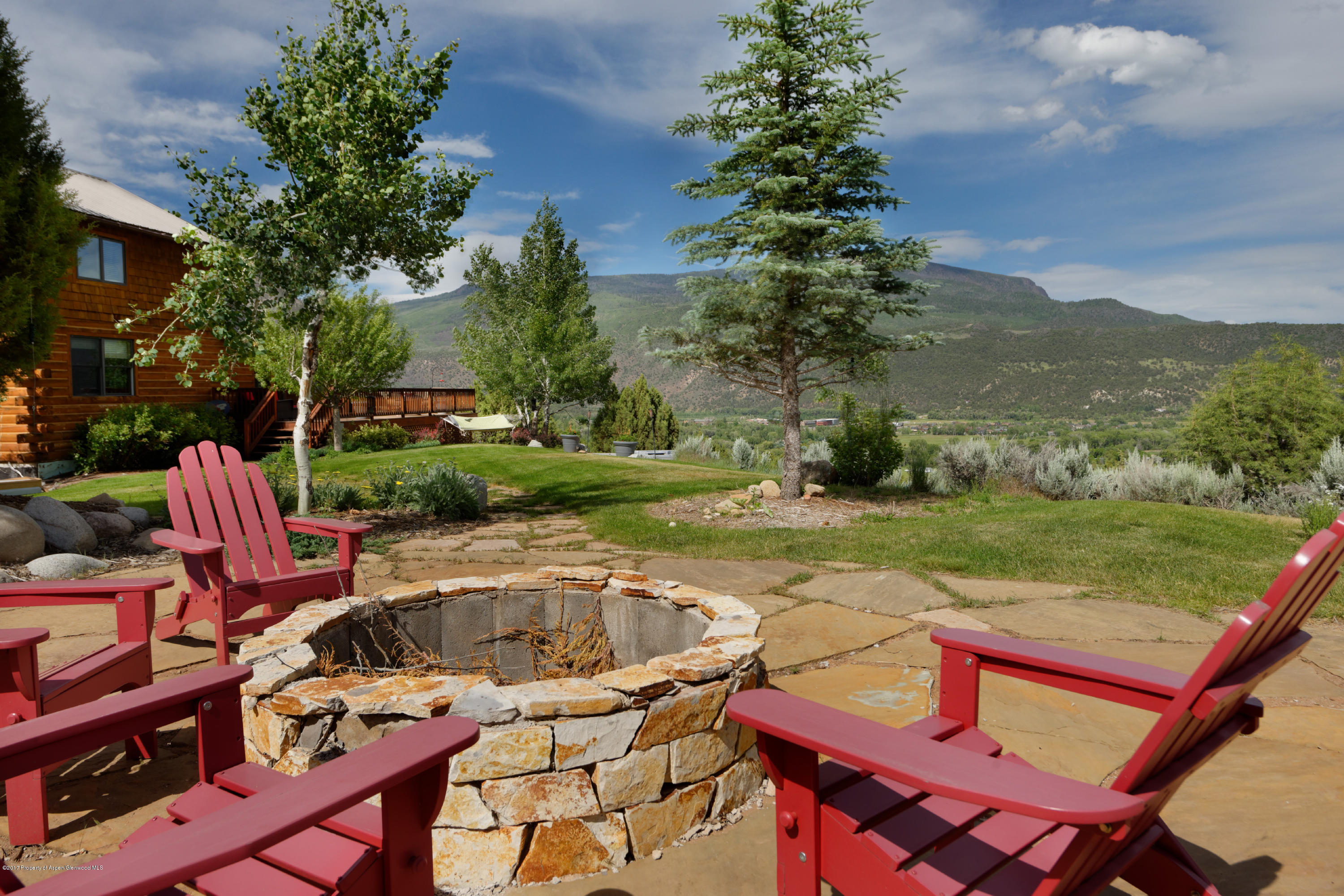 a view of a backyard with sitting area and garden