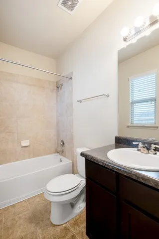 a bathroom with a granite countertop sink toilet a mirror and shower