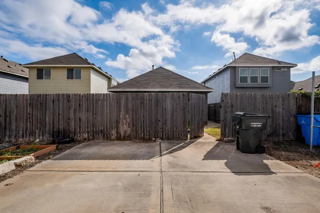 a backyard of a house with barbeque oven and outdoor seating