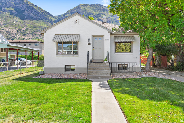 372 800 East Provo, UT 84606 - Photo 1 of 29 White brick exterior with a light gray front door and window awnings