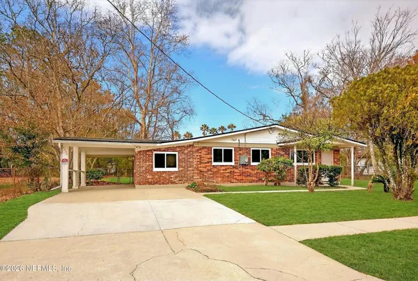 a front view of house with yard and green space