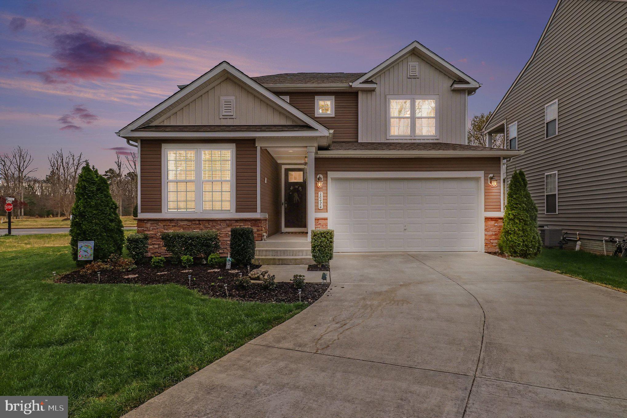 18474 Patriot Lane Ruther Glen, VA 22546 - Photo 1 of 25 a front view of a house with a yard and garage