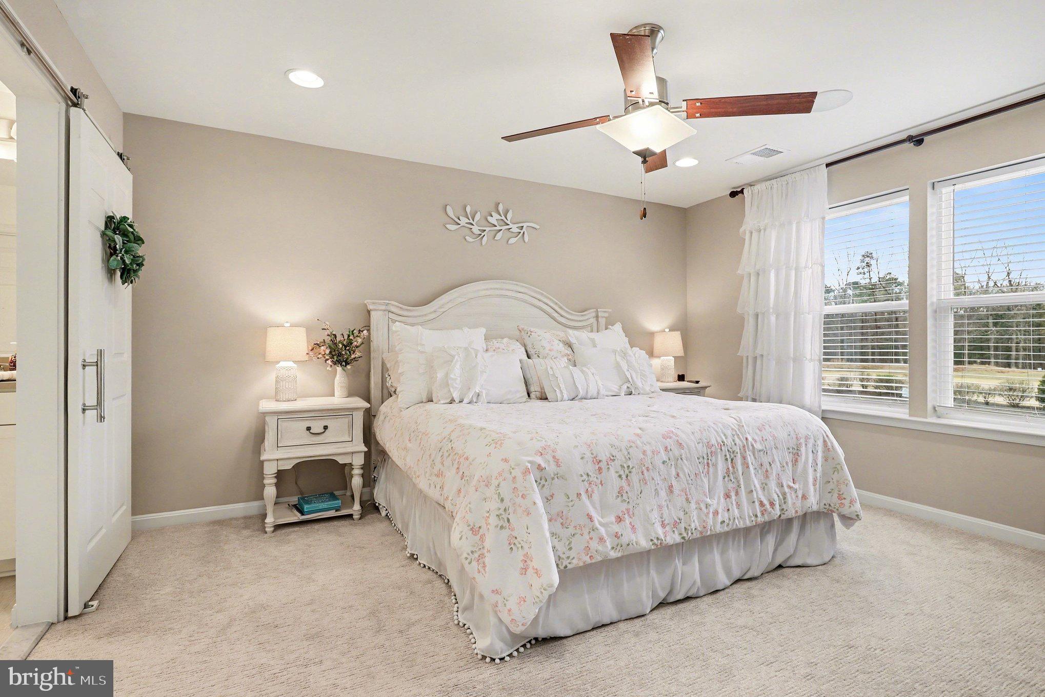18474 Patriot Lane Ruther Glen, VA 22546 - Photo 11 of 25 a bedroom with a bed and a chandelier