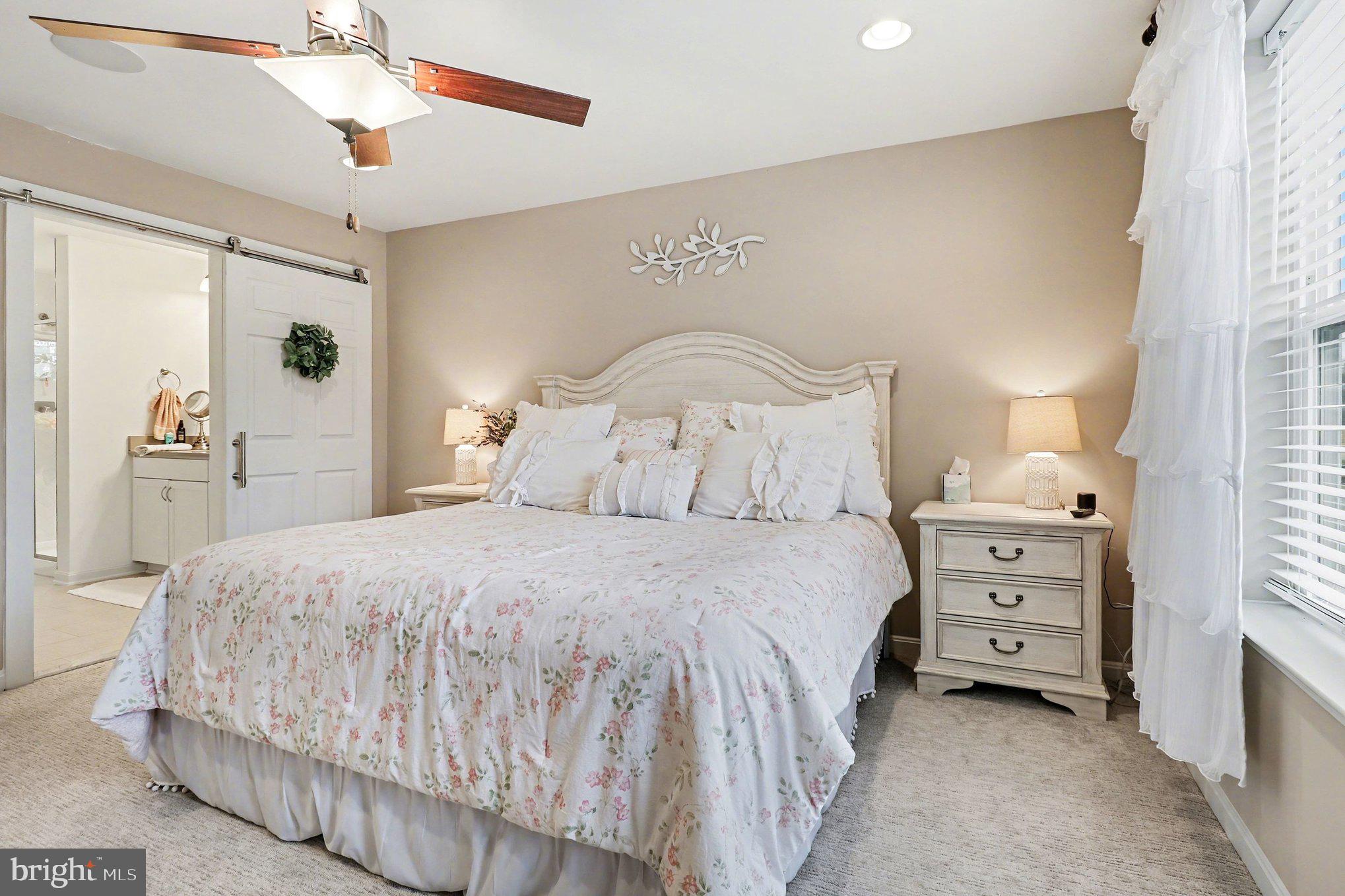 18474 Patriot Lane Ruther Glen, VA 22546 - Photo 12 of 25 a bedroom with a bed and a chandelier