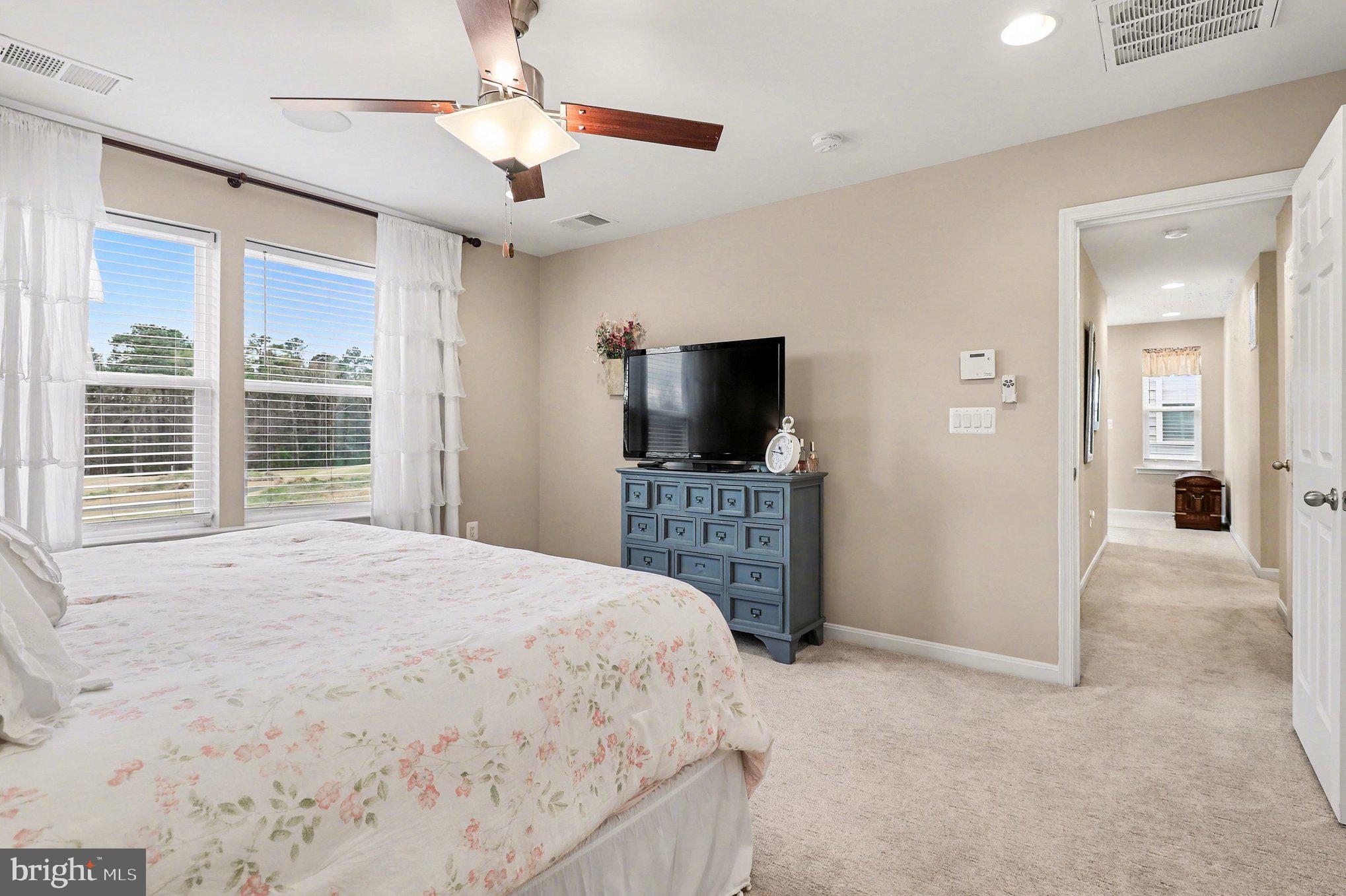 18474 Patriot Lane Ruther Glen, VA 22546 - Photo 13 of 25 a large bedroom with a bed and a flat screen tv