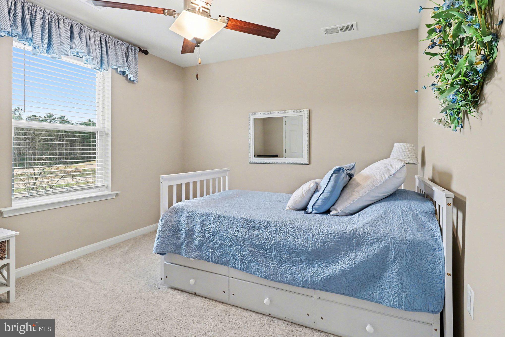 18474 Patriot Lane Ruther Glen, VA 22546 - Photo 14 of 25 a bedroom with a bed and a window