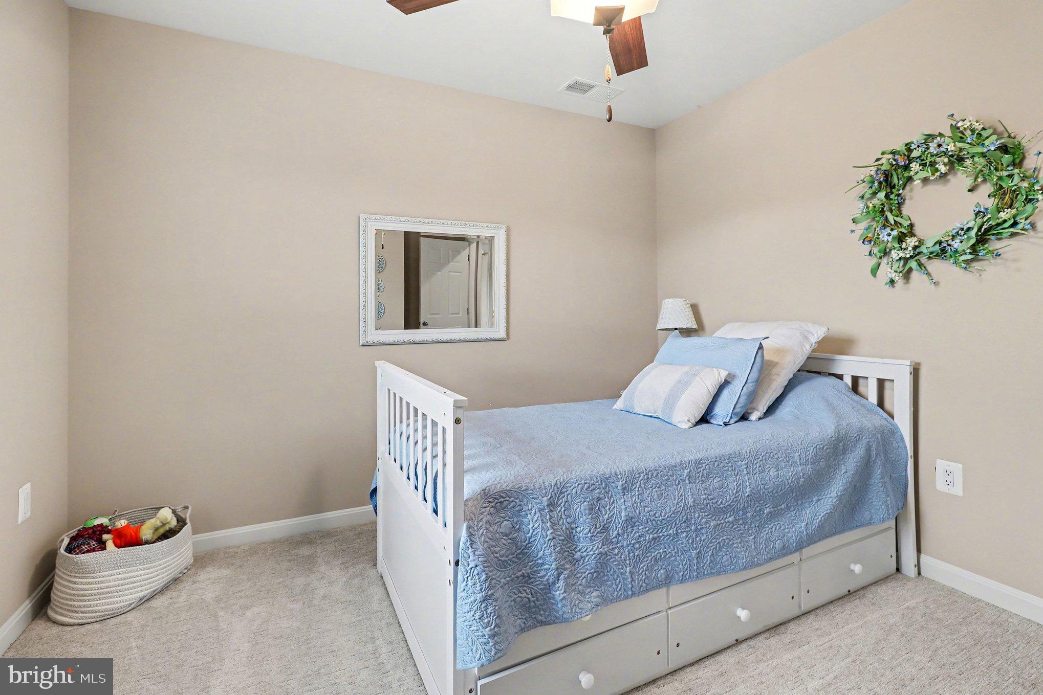 18474 Patriot Lane Ruther Glen, VA 22546 - Photo 15 of 25 a bedroom with a bed and a potted plant