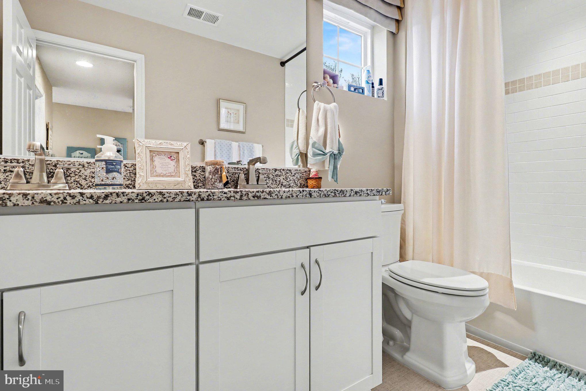 18474 Patriot Lane Ruther Glen, VA 22546 - Photo 20 of 25 a bathroom with a granite countertop sink mirror vanity and toilet