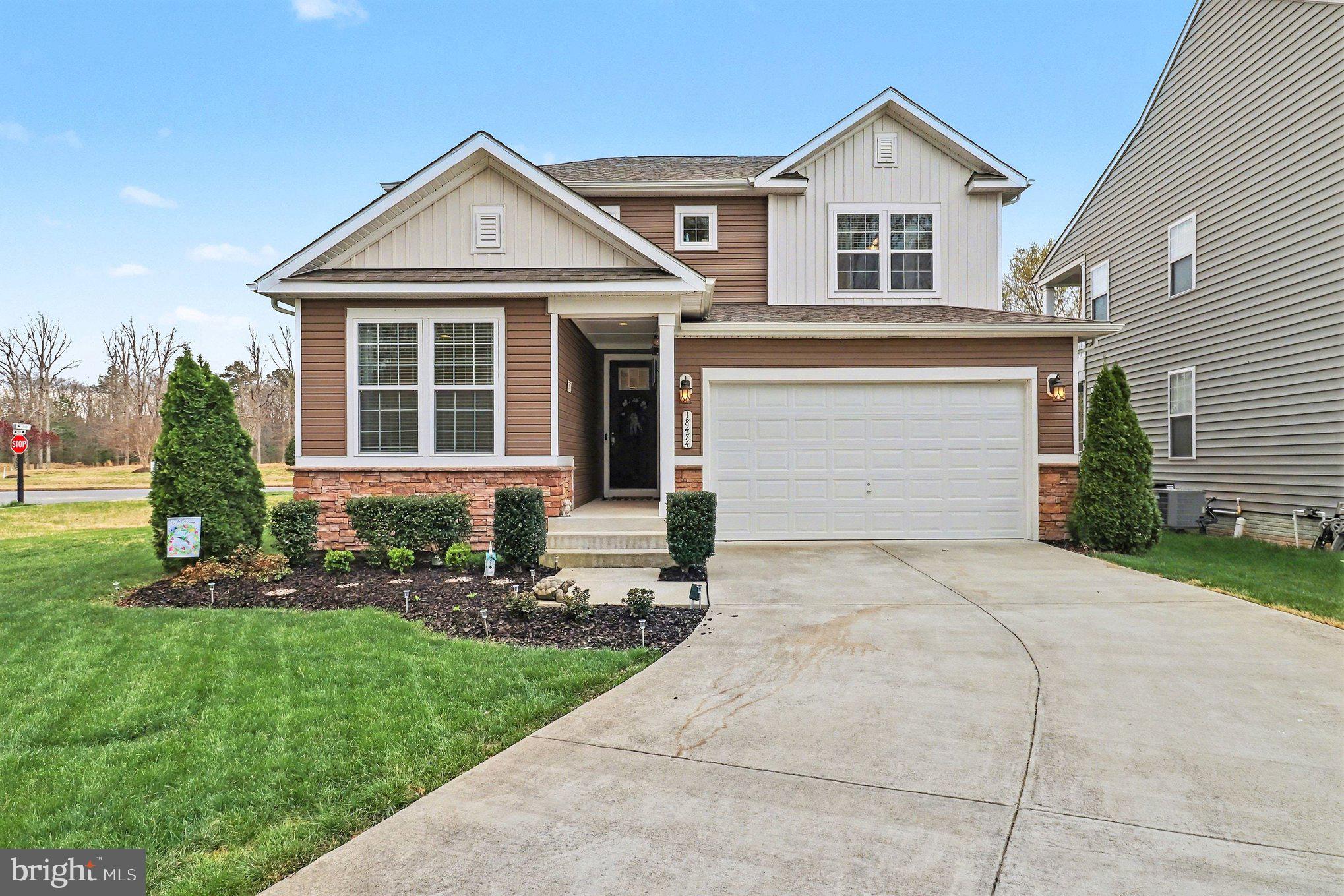 18474 Patriot Lane Ruther Glen, VA 22546 - Photo 2 of 25 a front view of a house with a yard and garage