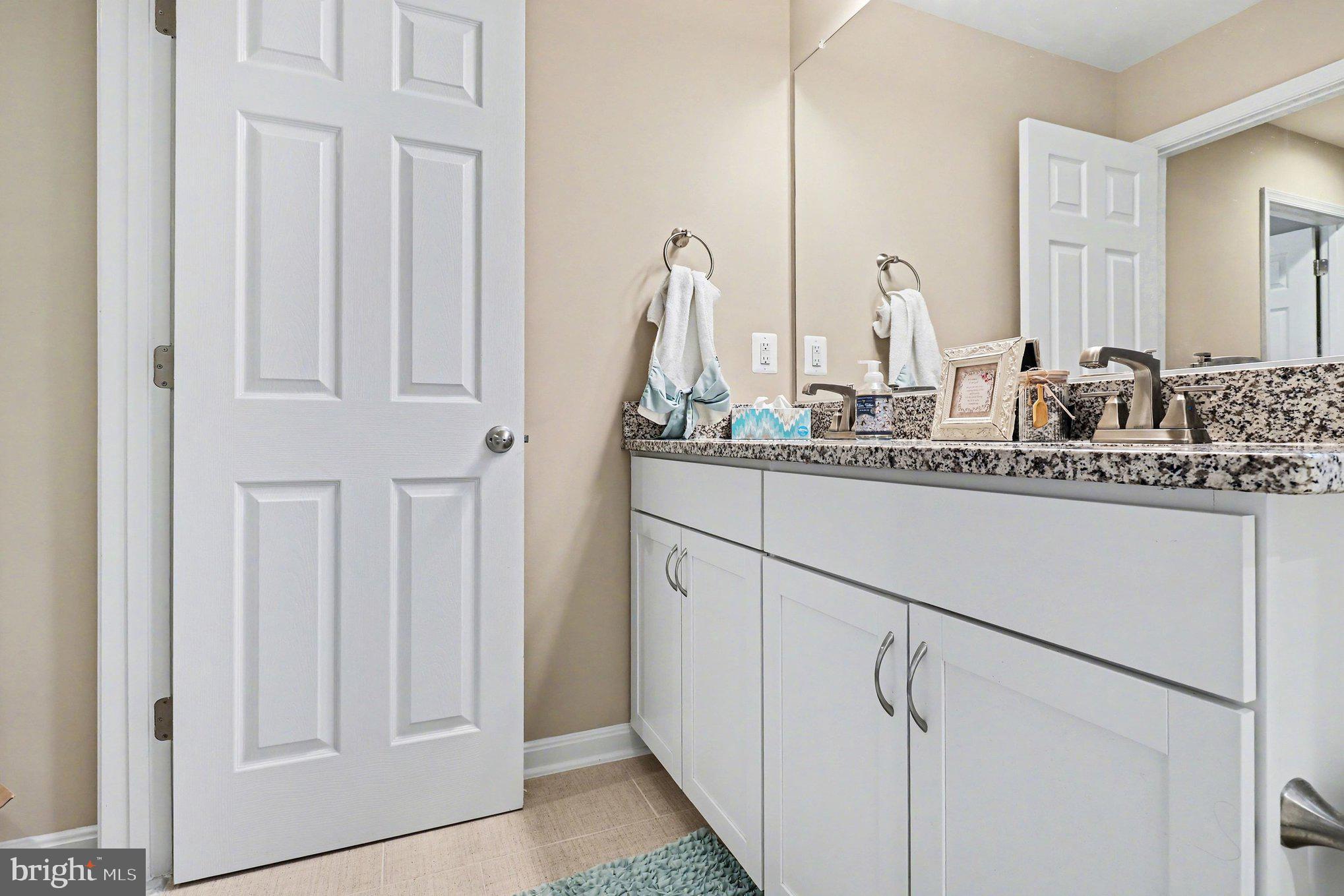 18474 Patriot Lane Ruther Glen, VA 22546 - Photo 21 of 25 a bathroom with a sink and a mirror