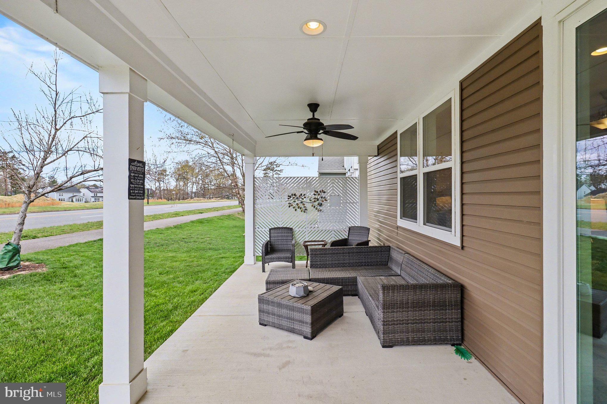 18474 Patriot Lane Ruther Glen, VA 22546 - Photo 24 of 25 a outdoor space with patio the couches and a dining table with garden view