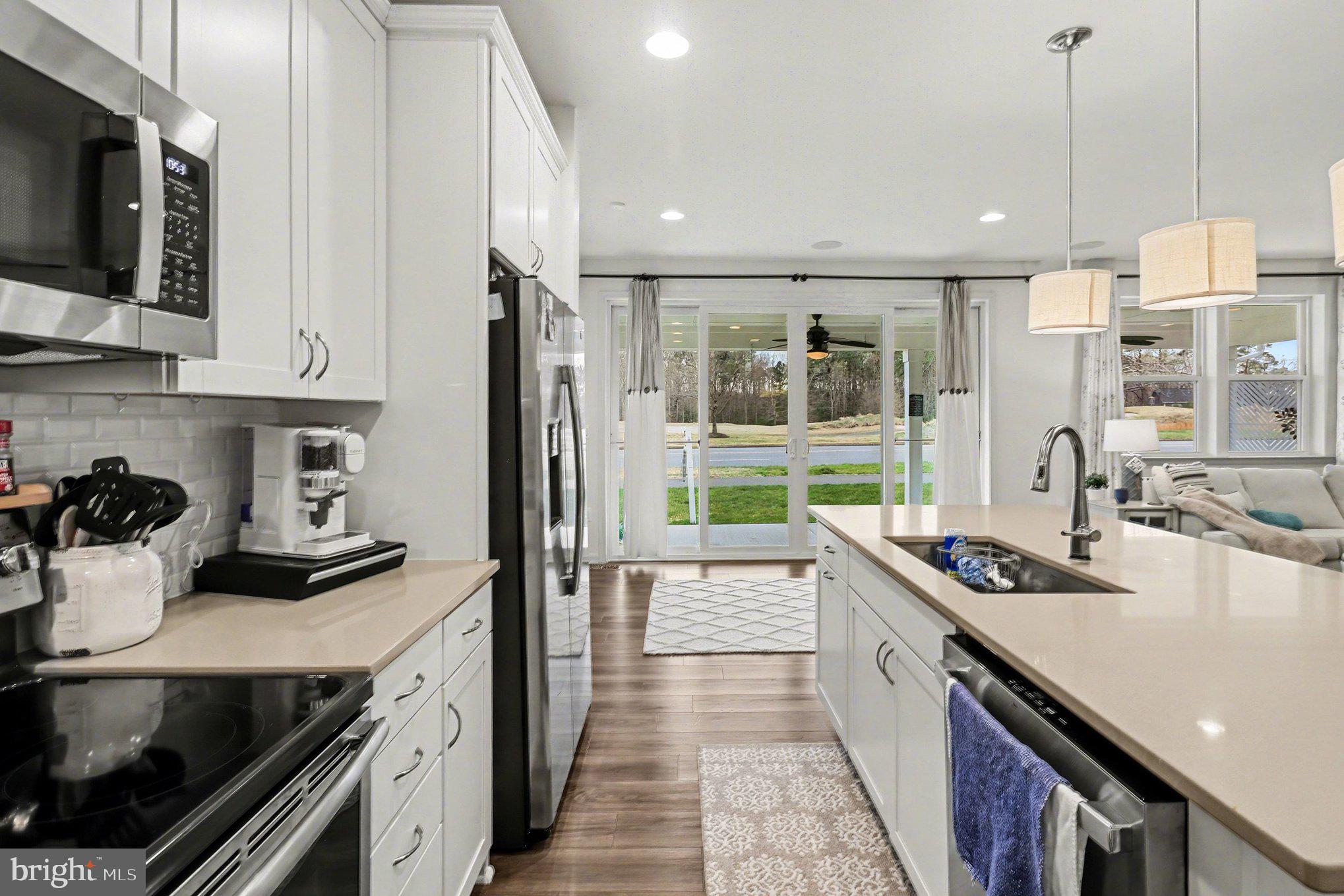 18474 Patriot Lane Ruther Glen, VA 22546 - Photo 7 of 25 a kitchen with stainless steel appliances granite countertop a sink stove and refrigerator