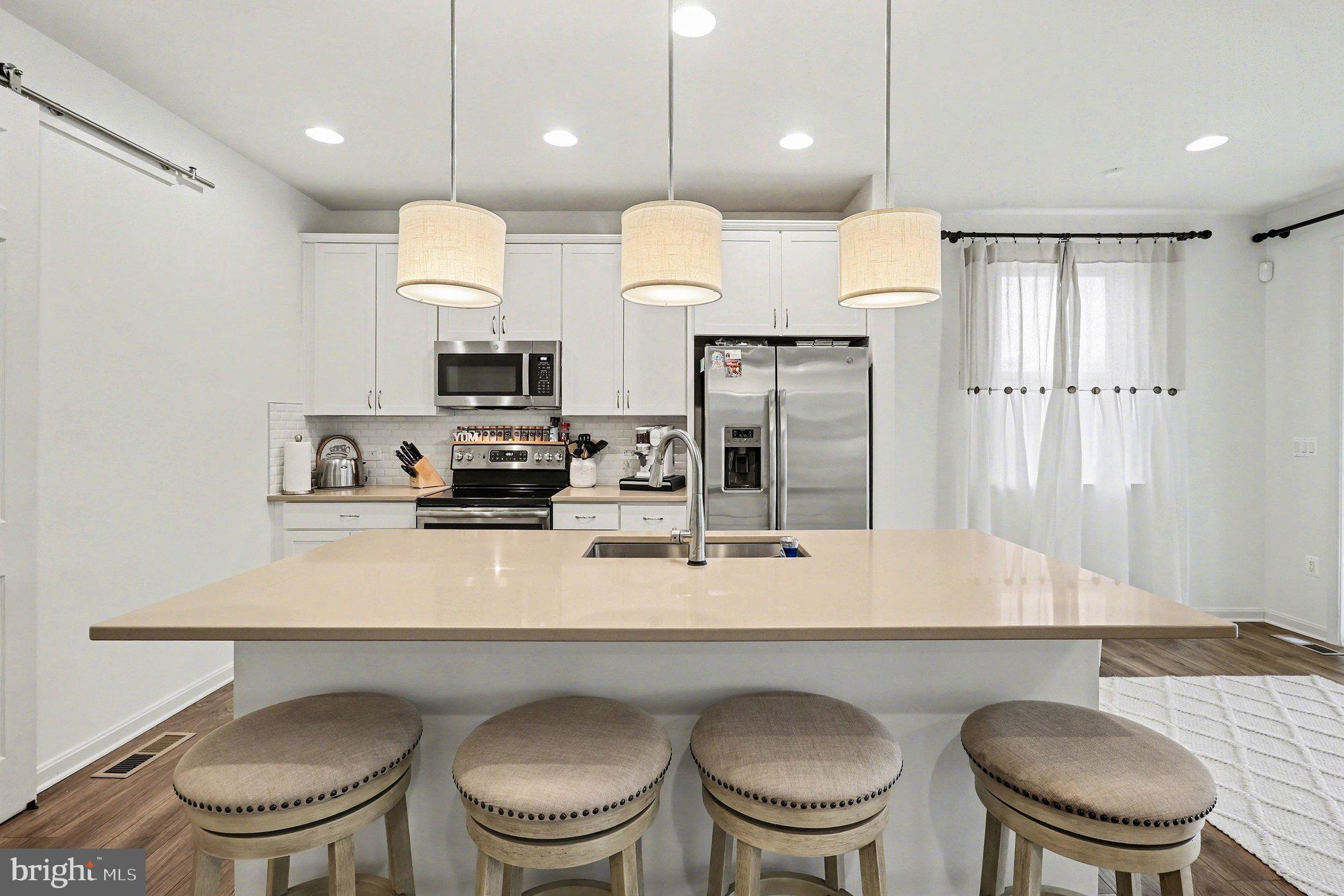 18474 Patriot Lane Ruther Glen, VA 22546 - Photo 10 of 25 a kitchen with a dining table chairs and a refrigerator