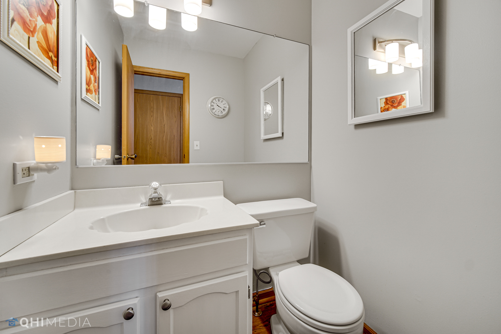 261 Ascot Lane Streamwood, IL 60107 - Photo 11 of 23 a white toilet sitting next to a bathroom sink