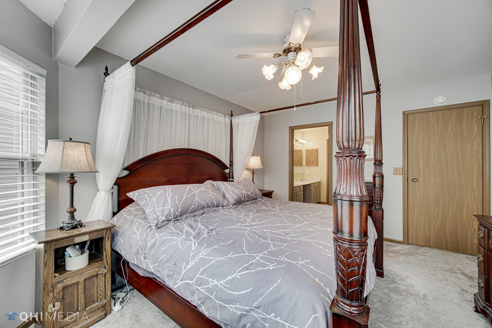261 Ascot Lane Streamwood, IL 60107 - Photo 14 of 23 a bedroom with a bed and a chandelier