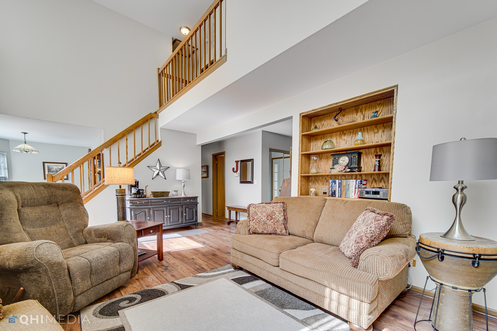261 Ascot Lane Streamwood, IL 60107 - Photo 4 of 23 a living room with a couch and a book shelf