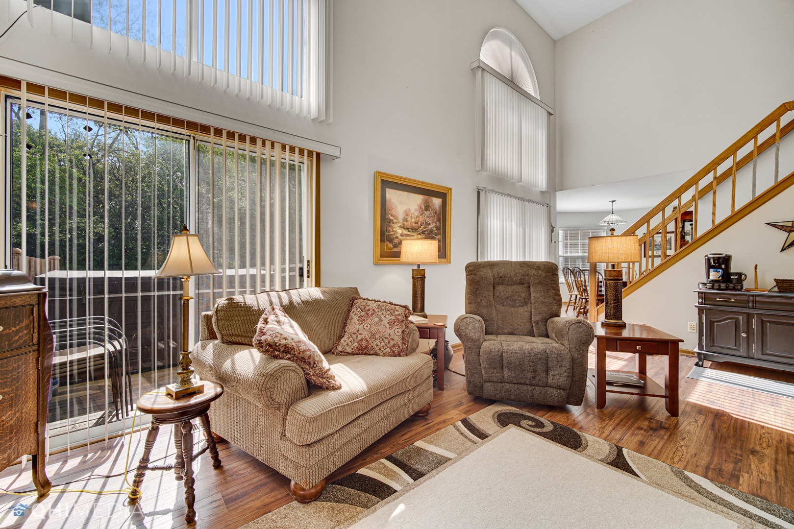 261 Ascot Lane Streamwood, IL 60107 - Photo 5 of 23 a living room with furniture and a floor to ceiling window