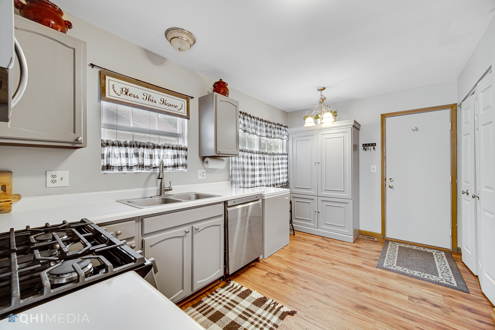 261 Ascot Lane Streamwood, IL 60107 - Photo 9 of 23 a kitchen with a sink stove and refrigerator