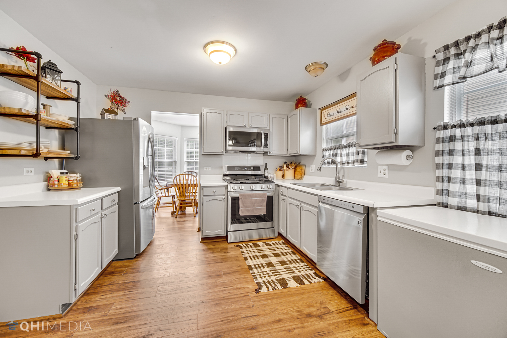 261 Ascot Lane Streamwood, IL 60107 - Photo 10 of 23 a kitchen with stainless steel appliances granite countertop a sink and cabinets