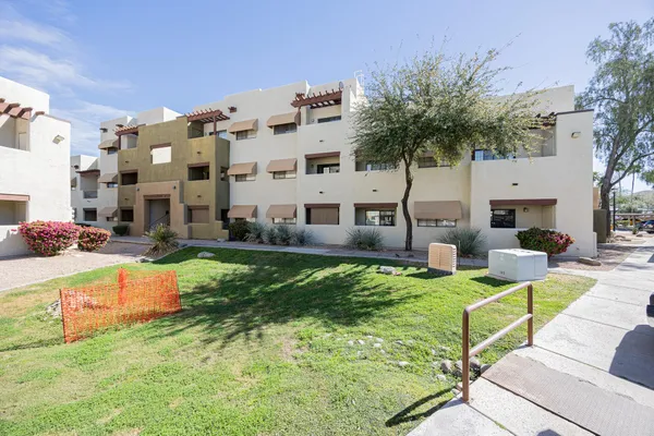 a view of a house with swimming pool and sitting area