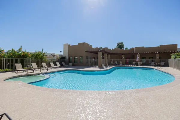 a view of a swimming pool and lounge chairs
