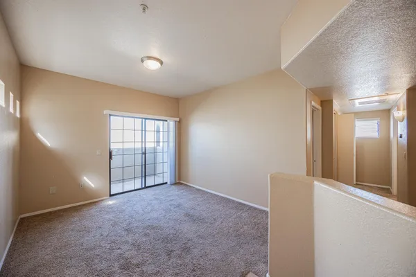 an empty room with windows and closet