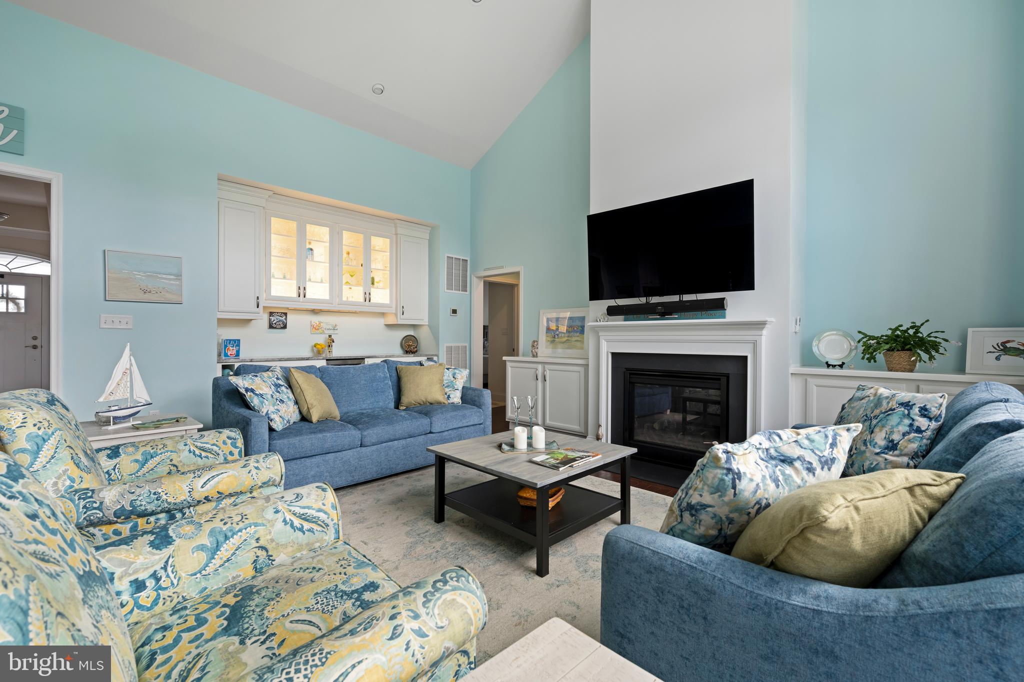 34017 Smiths Point Lane Lewes, DE 19958 - Photo 13 of 66 a living room with furniture a flat screen tv and a fireplace