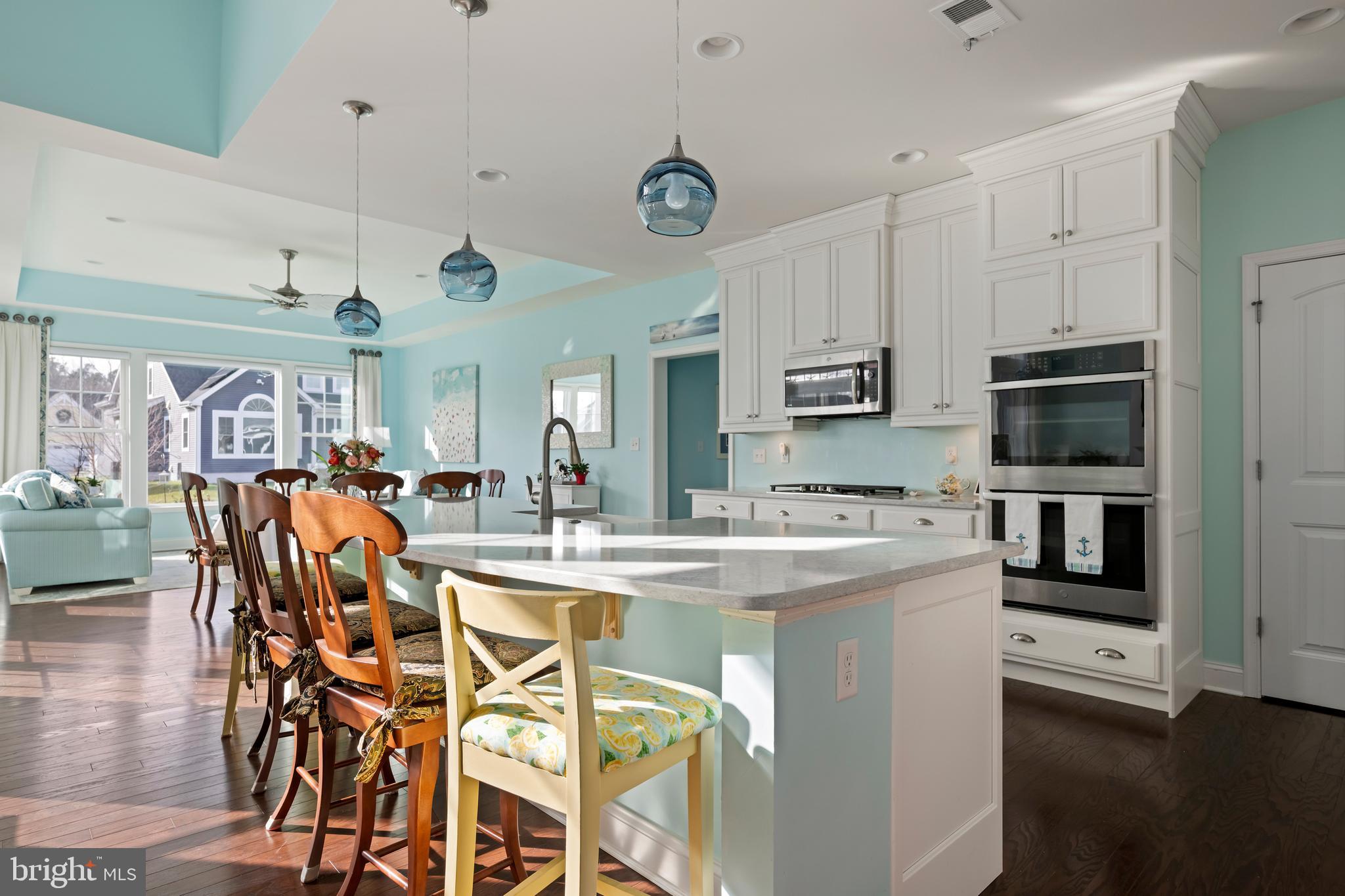 34017 Smiths Point Lane Lewes, DE 19958 - Photo 15 of 66 a large kitchen with a table and chairs