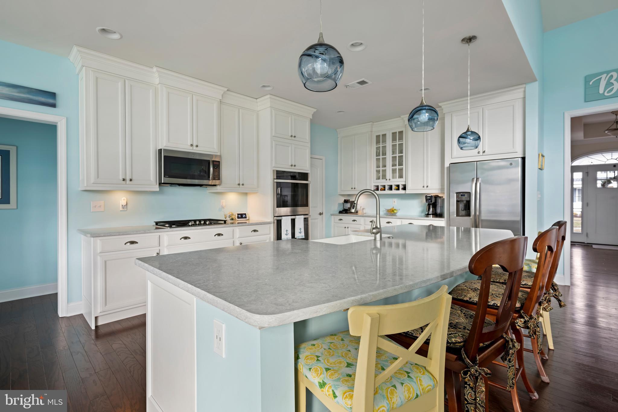 34017 Smiths Point Lane Lewes, DE 19958 - Photo 16 of 66 a kitchen with stainless steel appliances granite countertop a sink a stove and a refrigerator