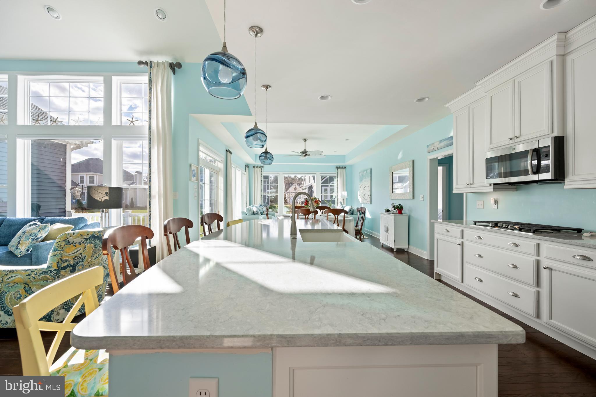 34017 Smiths Point Lane Lewes, DE 19958 - Photo 22 of 66 a large kitchen with kitchen island granite countertop a large counter top appliances and cabinets