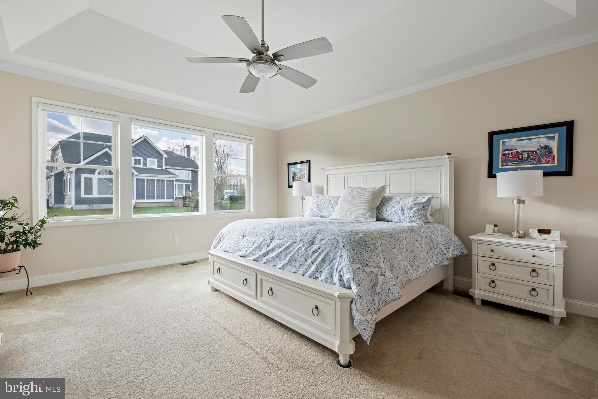 34017 Smiths Point Lane Lewes, DE 19958 - Photo 25 of 66 a spacious bedroom with a bed and a chandelier