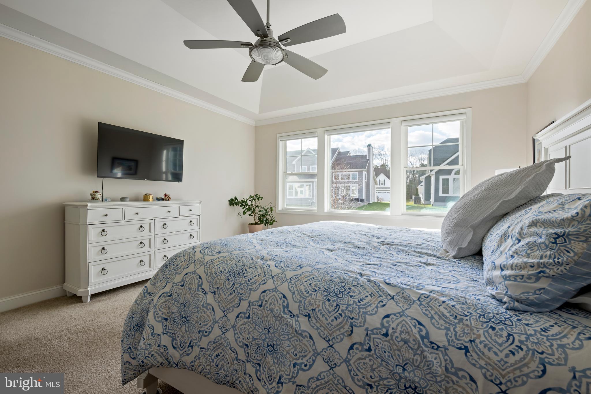 34017 Smiths Point Lane Lewes, DE 19958 - Photo 26 of 66 a bedroom with a bed a window and a flat screen television