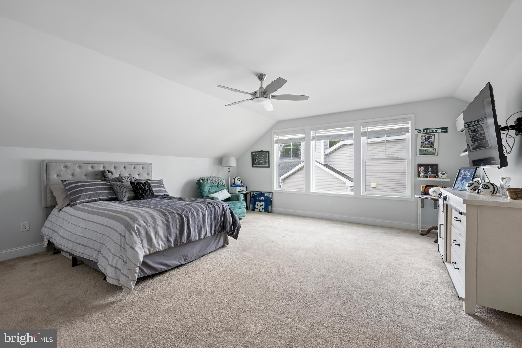 34017 Smiths Point Lane Lewes, DE 19958 - Photo 33 of 66 a spacious bedroom with a bed a dresser and flat screen tv